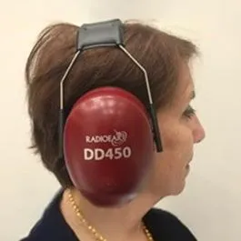 Woman undergoing a hyperacusis hearing evaluation